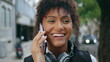 © stockbusters - Happy woman talking smartphone on city walk close up. African girl call outdoors