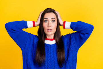 Poster - Portrait of funny hispanic woman wearing blue knit pullover hands touching head stressed staring isolated on yellow color background