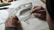 © Chimpanzky  - close up of a person's hand sketching a shark