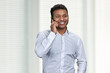 © DenisProduction.com - Portrait of happy smiling young businessman talking on mobile phone. Cheerful male executive talks on cell phone indoor.