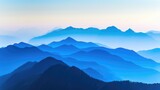 Fototapeta Natura - Serene blue layers of mountains fading into the horizon at dusk