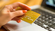 Online shopping, online payment, online banking and financial transaction success concept. Woman hand holding credit card with keyboard computer laptop on background.