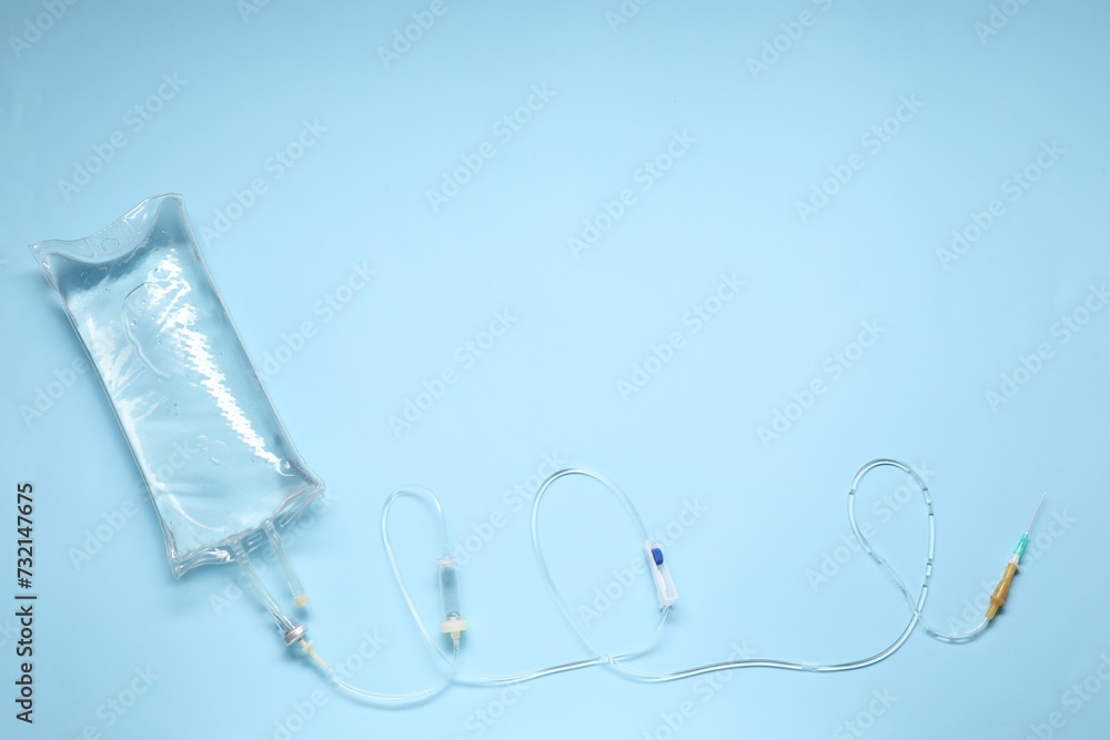 Infusion Set Background IV infusion set on light blue background, top view. Space for text ...