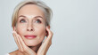 © Mrt - Close up portrait of a gorgeous, beautiful  mid aged, 50s mature woman touching her smooth healthy skin. Anti aging, skin care, cosmetic, spa, bodycare, wrinkles treatment concept with copy space for