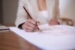 © Miko/peopleimages.com - Fashion designer, hands or drawing on paper with pencil in startup office of small business. Creative, closeup or tailor sketch at desk for project illustration, planning or writing ideas for clothes