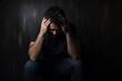 © AspctStyle - Distressed Man Sitting with Hands on Head in Dark Room. Mental Health and Despair Concept