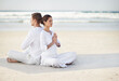 © Hover/peopleimages.com - Couple, yoga and sea with meditation, sitting or waves by sand in morning with mindfulness outdoor. Man, woman and peace for namaste with spiritual growth, balance or zen at beach in Cape Town