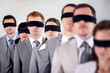 Business people, blindfold and employees lost at work, together and coworkers trust in workplace. Blind, team and collaboration in uncertainty, control strategy and support in challenge or workforce