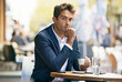 © Katie/peopleimages.com - Business, man and portrait outdoor at cafe or entrepreneur relax and thinking at table with espresso. Professional, customer or person planning schedule at coffee shop with latte to drink in morning