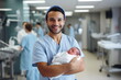 man obstetrician hold a newborn baby in the clinic