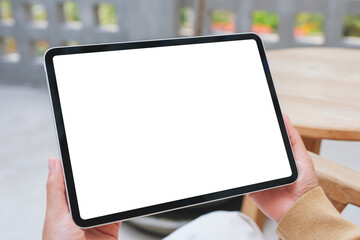 Mockup image of a woman holding digital tablet with blank white desktop screen