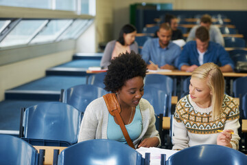 Poster - Discussion, university and women students in classroom with textbooks and documents for information. Smile, conversation and female friends talking and studying for college test, exam or assignment.