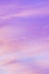 Wall Mural - Sky with soft and fluffy pastel orange pink and blue colored clouds. Sunset background. Nature. sunrise. Vertical