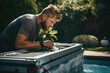 © Fotograf - A man is seen washing his hands in a pool. This image can be used to illustrate personal hygiene or cleanliness.