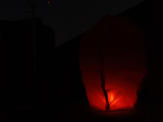 Picture of a person holding a sky lantern shot on the festival of Makar Sankranti