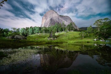 Wall Mural - Tranquil, picturesque landscape featuring a lush forest with a mountain peak reflecting in a lake