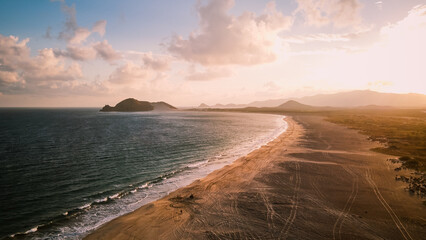 Poster - a wide sandy beach with waves coming in from the ocean