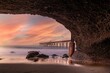 Idyllic beach with pristine golden sand and a bridge over ocean at sunset in Catherine Hill Bay