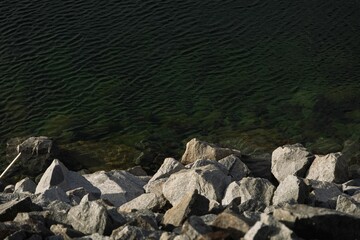 Poster - Peaceful body of water surrounded by large rocky formations, offering a scenic and calming view