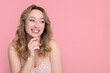 © New Africa - Portrait of smiling woman on pink background. Space for text