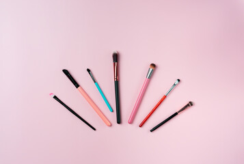 Canvas Print - Makeup brushes on pink background. Top view point, flat lay.