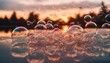 Soap bubbles glistening on a surface, illuminated by the warm hues of a sunset.
