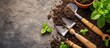 A shovel, rake, and trowel rest atop a mound of soil, ready to assist in gardening tasks like planting water, tending to grass, or maintaining a garden event.
