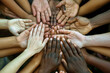© ink drop - A group of multicultural people with their hands together. Diverse community teamwork