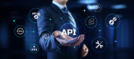 API Application programming interface. Businessman pressing virtual button.