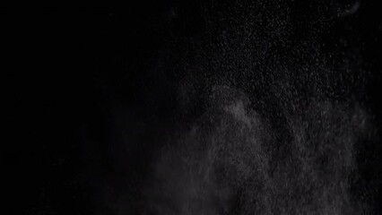 Exploding Stream of Ice Water Drops, Dust in Empty Space on a Black Background. Spraying. Abstract. Texture. Flash of dynamic particles of dust, powder, water. Rotate, swirl. Blurred motion. Cosmos.