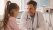 © Studio Nova - male doctor in a white coat with a stethoscope around his neck smiling and holding a young girl's hand