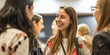 © RemsH - meeting within a company, networking at a reception, group of employees, businesswomen chatting at a networking event, sharing and chatting with a smile