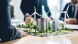 Close-up design of new houses with wind turbines to generate clean electricity. The men of the company solve problems, share their experience in the office.