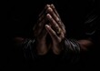 praying hands on black background