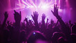 © MP Studio - lively crowd at a concert, with hands raised in the air, silhouetted against a backdrop of vibrant stage lights, capturing the energy and excitement of a live music event.
