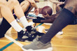 © Marko Geber - Young people taking a break from playing basketball in an indoor basketball gym
