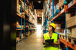© Davor - Young woman warehouse supervisor with clipboard