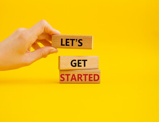 Wall Mural - lets get started symbol. concept words lets get started on wooden blocks. beautiful yellow backgroun