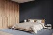 Stylish hotel bedroom interior with bed, nightstand and mock up wall