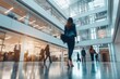 © ERiK - Bright business workplace with people walking in blurred motion in modern office building