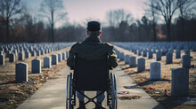 Military Veteran In A Wheelchair. Military Cemetery