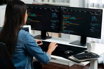young asian in it developer creating with typing online information on pc with coding program data o