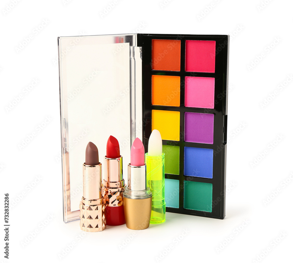 Different lipsticks and eyeshadows on white background on white background