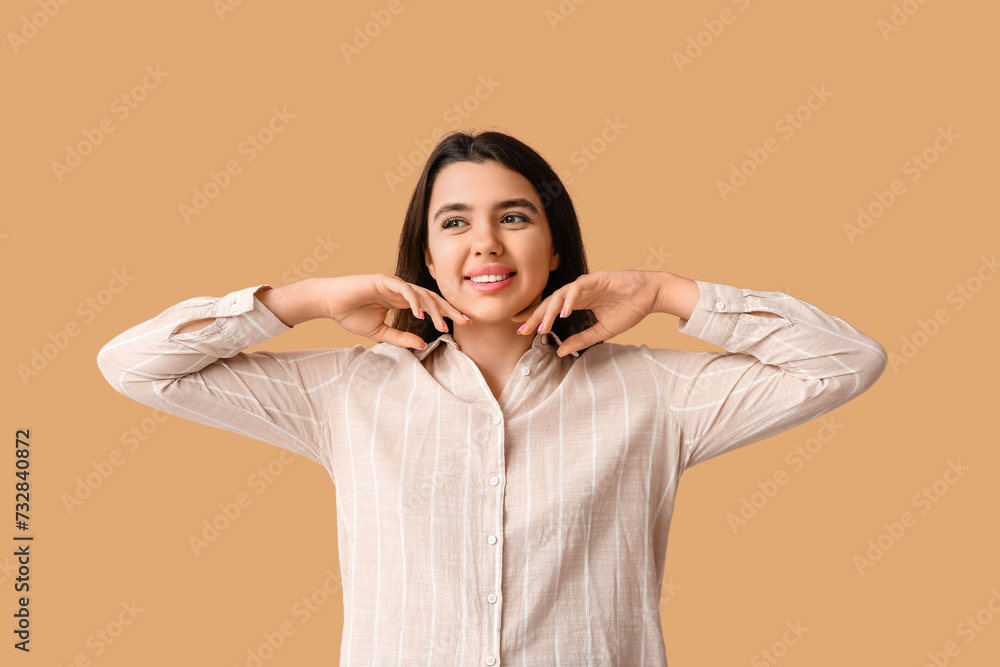 Young happy smiling woman on beige background