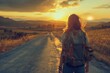 Young woman pursues her own independent path, walks backwards towards the sunset. Copy space.