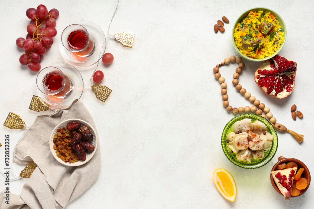 Traditional Eastern dishes and prayer beads on white table. Ramadan celebration