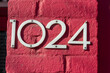 the number 1024 on a painted brick surface