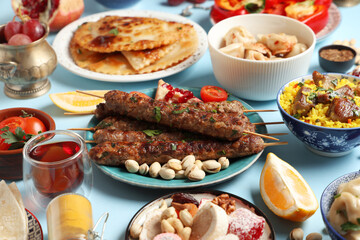 Wall Mural - Traditional Eastern dishes on blue background, closeup. Ramadan celebration