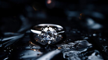 Jewelry ring with a big diamond on dark coal.
