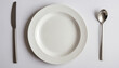 Top view of a blank white plate on the table